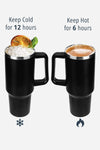 Two black looselyboho Indestructible Travel Cups with handles are shown. The left cup contains ice, mint leaves, and a slice of orange, indicating it keeps drinks cold for 12 hours. The right cup contains a hot beverage, showing it keeps drinks hot for 6 hours. Each spill-proof travel tumbler ensures convenience on the go.